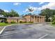 Brick building with peach shutters and large columns, set against a blue sky at 416 Banyon Tree Cir # 108, Maitland, FL 32751