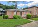 Charming brick home with lush lawn, featuring a palm tree and colorful peach shutters at 416 Banyon Tree Cir # 108, Maitland, FL 32751