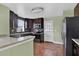 Modern kitchen featuring stainless steel appliances, dark cabinetry, and granite countertops at 416 Banyon Tree Cir # 108, Maitland, FL 32751