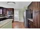 Modern kitchen featuring stainless steel appliances, dark cabinetry, and granite countertops at 416 Banyon Tree Cir # 108, Maitland, FL 32751