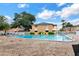 Community pool with ample seating and a secure fence at 416 Banyon Tree Cir # 108, Maitland, FL 32751