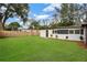 Exterior of home with lush backyard and small landscaping at 4201 Mizell St, Orlando, FL 32812