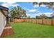 Large backyard with lush green grass and privacy fence at 4201 Mizell St, Orlando, FL 32812