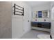 Bathroom with sleek vanity, heated towel rack and dual sinks with backlit mirrors at 4201 Mizell St, Orlando, FL 32812