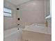 Contemporary bathroom showcasing a white tub and shower with a stylish floating sink at 4201 Mizell St, Orlando, FL 32812