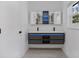 Modern bathroom with double sink vanity, illuminated mirrors and under-cabinet lighting at 4201 Mizell St, Orlando, FL 32812