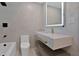 Modern bathroom featuring marble walls, sleek floating vanity, and illuminated mirror at 4201 Mizell St, Orlando, FL 32812