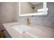 Close up on a luxurious bathroom vanity with marble countertop and golden faucet at 4201 Mizell St, Orlando, FL 32812