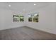 Cozy bedroom featuring two windows with natural light, and wood-look flooring at 4201 Mizell St, Orlando, FL 32812