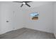 Cozy bedroom features a ceiling fan, hardwood floors, and natural light at 4201 Mizell St, Orlando, FL 32812