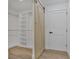 Walk-in closet with custom shelving and sliding barn door at 4201 Mizell St, Orlando, FL 32812