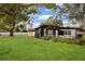 Home with a manicured front lawn on a sunny day at 4201 Mizell St, Orlando, FL 32812