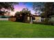 Home with a manicured front lawn at dusk at 4201 Mizell St, Orlando, FL 32812