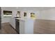Open-concept kitchen with a large island, stainless steel appliances, and bright, natural light at 4201 Mizell St, Orlando, FL 32812