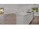 Stylish kitchen with a sleek island, stainless steel appliances, and an open view into the living area at 4201 Mizell St, Orlando, FL 32812