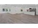 Bright, open-concept living area with wood-look floors, connecting seamlessly to the modern white kitchen at 4201 Mizell St, Orlando, FL 32812