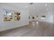 Bright living room featuring wood-look flooring, recessed lighting, and large windows at 4201 Mizell St, Orlando, FL 32812