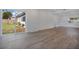 Bright living space with wood-look flooring, a sliding glass door, and neutral decor at 4201 Mizell St, Orlando, FL 32812