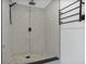 Walk-in shower with modern fixtures and decorative mosaic tile accent strip at 4201 Mizell St, Orlando, FL 32812