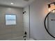 Bathroom featuring decorative tile walls, a tub and shower, and modern vanity lighting at 468 Marion Oaks Blvd, Ocala, FL 34473