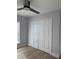 A bedroom featuring a ceiling fan and large closet doors at 468 Marion Oaks Blvd, Ocala, FL 34473