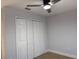 Bedroom featuring light gray walls, ceiling fan, and closet with bifold doors at 468 Marion Oaks Blvd, Ocala, FL 34473