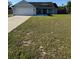 Charming single-story home with a well-manicured lawn and a two-car garage at 468 Marion Oaks Blvd, Ocala, FL 34473