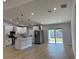 Open concept kitchen with stainless steel appliances, a kitchen island, and hardwood floors at 468 Marion Oaks Blvd, Ocala, FL 34473