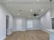 Spacious living room with light wood flooring, neutral walls, and a ceiling fan at 468 Marion Oaks Blvd, Ocala, FL 34473