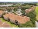 Aerial view of a well-maintained community with lush landscaping, parking, and a pool at 527 Villa Del Sol Cir # 104, Orlando, FL 32824