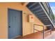 Entry door to unit 104 with stairway access, and an included fire safety box at 527 Villa Del Sol Cir # 104, Orlando, FL 32824