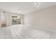 Bright living room with tile floors, fan, and sliding door access to the screened lanai at 527 Villa Del Sol Cir # 104, Orlando, FL 32824
