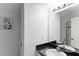 Contemporary bathroom with dark vanity, a sleek faucet, and a shower with a glass door at 558 Cadiz Loop, Davenport, FL 33837