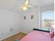 Cozy bedroom featuring a pink daybed with a ceiling fan and natural light at 558 Cadiz Loop, Davenport, FL 33837