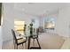 Dining area with modern table and chairs, flooded with natural light from large windows at 558 Cadiz Loop, Davenport, FL 33837