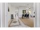 Bright and open entryway with tile flooring, staircase and adjacent dining room at 558 Cadiz Loop, Davenport, FL 33837