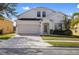 Charming two-story home with a brick driveway and attached two-car garage in a well-maintained community at 558 Cadiz Loop, Davenport, FL 33837