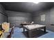 Spacious game room featuring an air hockey table and finished garage with a painted black brick wall at 558 Cadiz Loop, Davenport, FL 33837