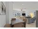 Open concept kitchen with modern appliances and view of the living room and screened-in lanai at 558 Cadiz Loop, Davenport, FL 33837