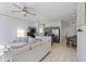 Spacious living room featuring tile floors, a sectional sofa, and an open layout to the kitchen at 558 Cadiz Loop, Davenport, FL 33837