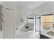 Main bathroom features a separate soaking tub, glass-enclosed shower, and updated vanity at 558 Cadiz Loop, Davenport, FL 33837