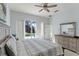 Spacious main bedroom boasts ample natural light and views of the pool area from the sliding door at 558 Cadiz Loop, Davenport, FL 33837