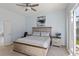 Main bedroom features a king bed, ceiling fan, and sliding glass door to the screened-in lanai at 558 Cadiz Loop, Davenport, FL 33837
