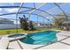 Beautiful screened-in pool and spa area with a view of the fenced backyard at 558 Cadiz Loop, Davenport, FL 33837
