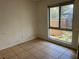 Modest bedroom with tiled floors, a single window, and simple design awaiting personalization at 5918 Stratton Ln, Orlando, FL 32808