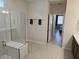 Modern bathroom with glass-enclosed shower, bench seating, and towel racks at 6129 Citrus Grove Ct, St Cloud, FL 34771