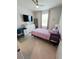 Bedroom with a pink bedspread, tv, desk, and window view at 6129 Citrus Grove Ct, St Cloud, FL 34771