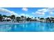 Stunning resort-style pool with lounge chairs, palm trees, and a spacious deck for relaxation and recreation at 6129 Citrus Grove Ct, St Cloud, FL 34771