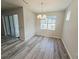 Bright dining area with natural light and modern chandelier, complemented by stylish wood-look flooring at 6129 Citrus Grove Ct, St Cloud, FL 34771