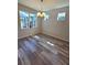 Bright dining room featuring wood-look flooring and modern lighting at 6129 Citrus Grove Ct, St Cloud, FL 34771
